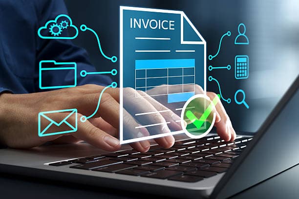 Glowing digital invoice on a laptop screen with AI extraction icons