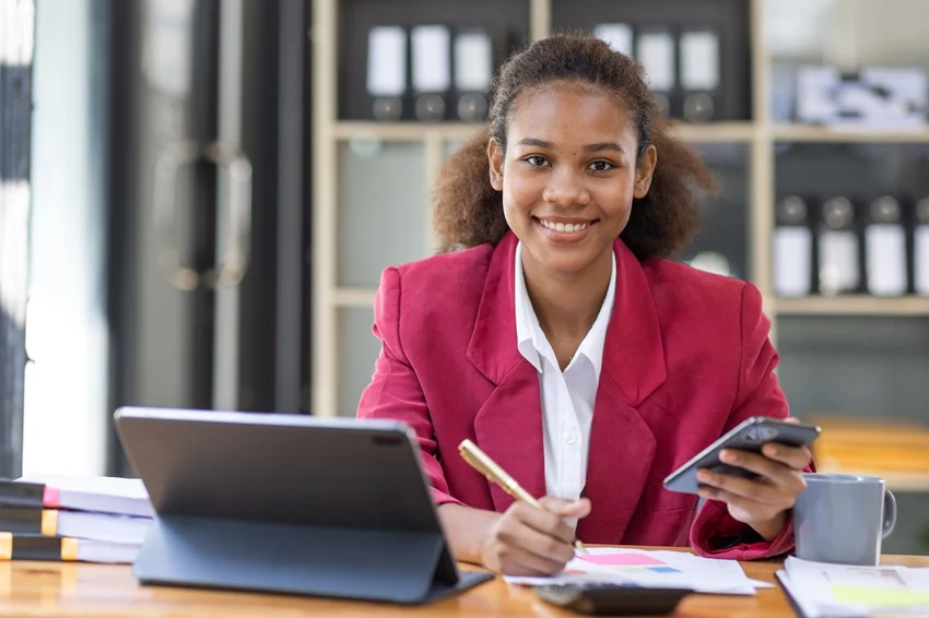 A bookkeeper at her desk reviewing paperwork