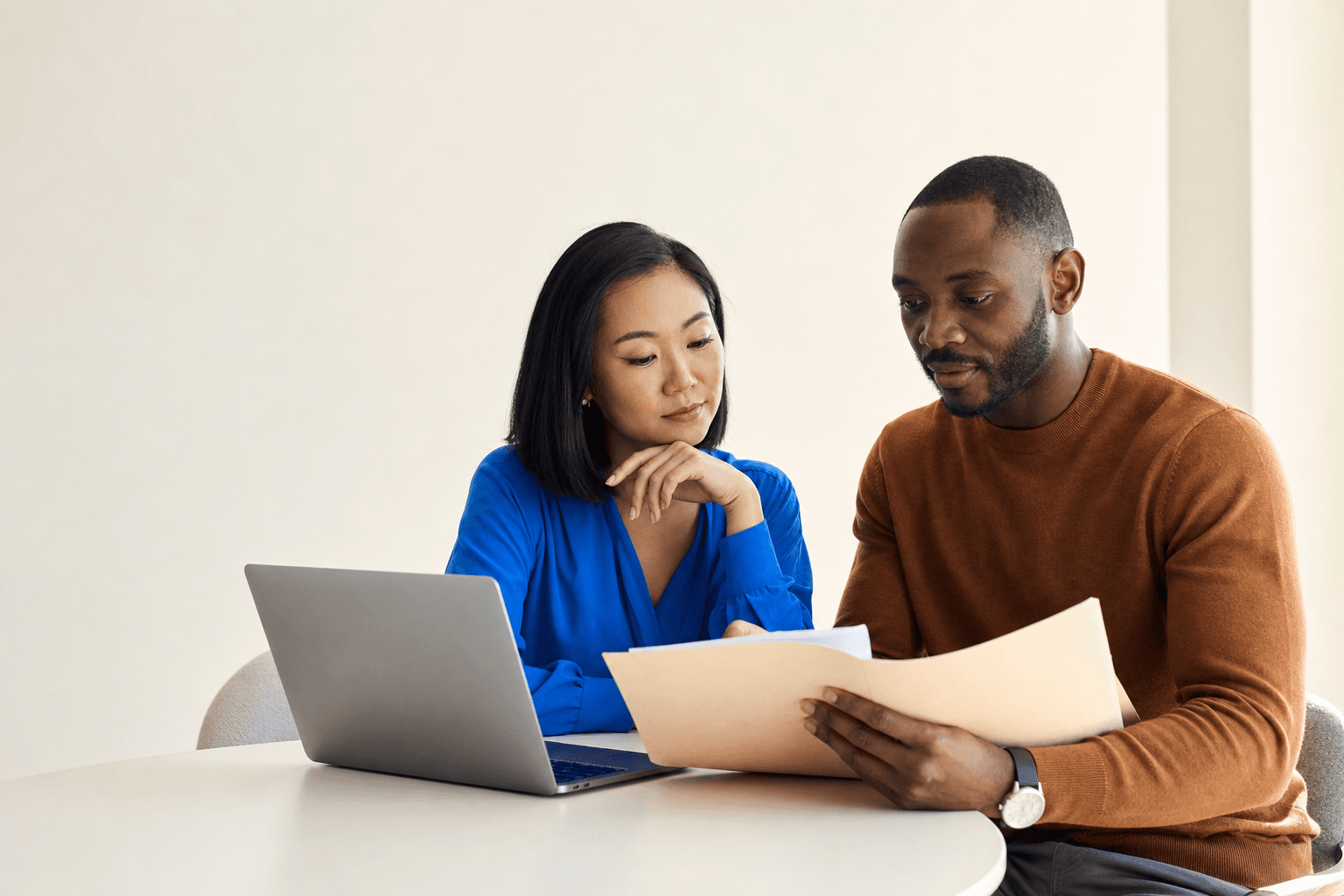 Two accounting professionals discussing a document batch together