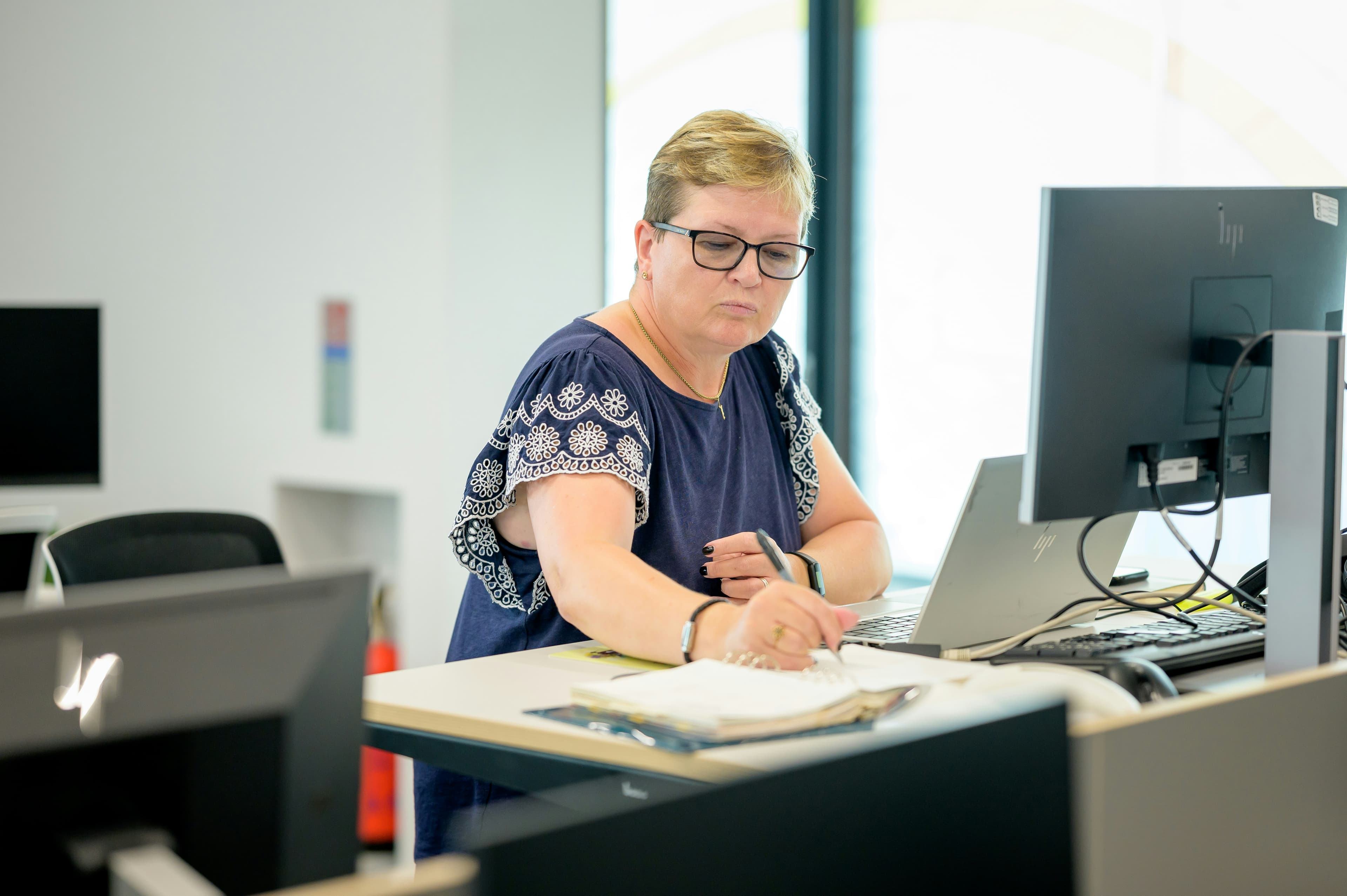 An accountant working through paperwork at a desk