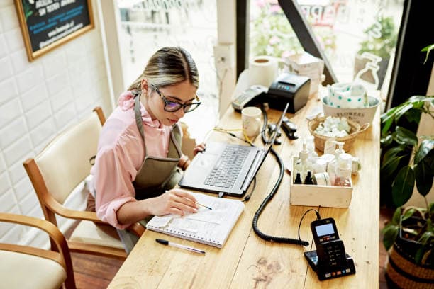 A small-business owner doing the books at the counter